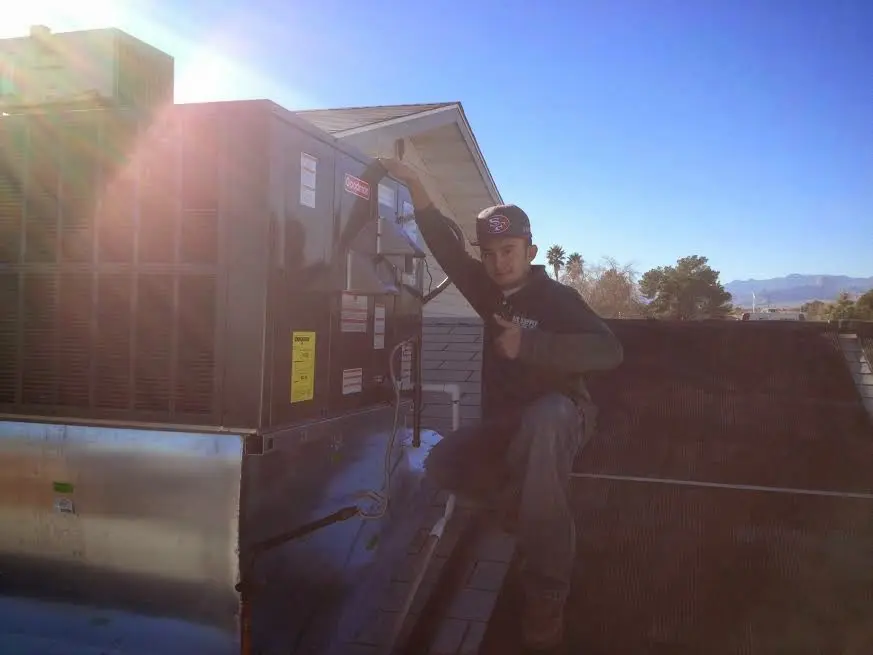 HVAC technician performing Air Duct Repair on a rooftop unit in Hainesport